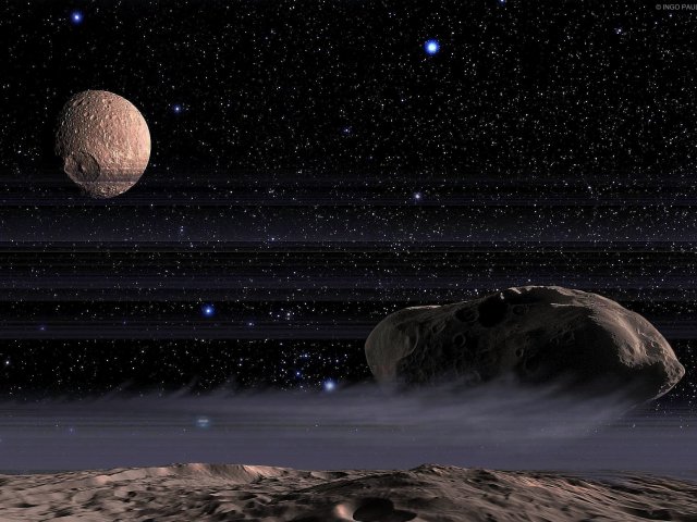 Eisschleier hinter sich herziehend, nähern sich die Saturnmonde Pandora und Prometheus auf 60 km Abstand und tauschen dabei die Positionen am Innen- und Außenrand ihres Ringes.