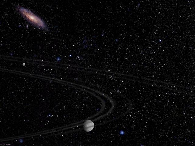 Tethys und Dione. Tethys bewegt sich hier unterhalb der Ringebene des Saturns, dessen Ringe sich aus diesem Winkel nur schwach abbilden. In Hintergrund steht die Nachbargalaxie Andromeda.